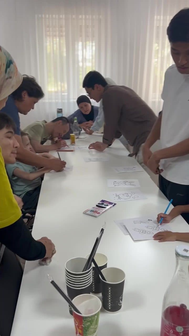 Children and facilitators working through FlexiKeys drawing activities together at the rehabilitation center